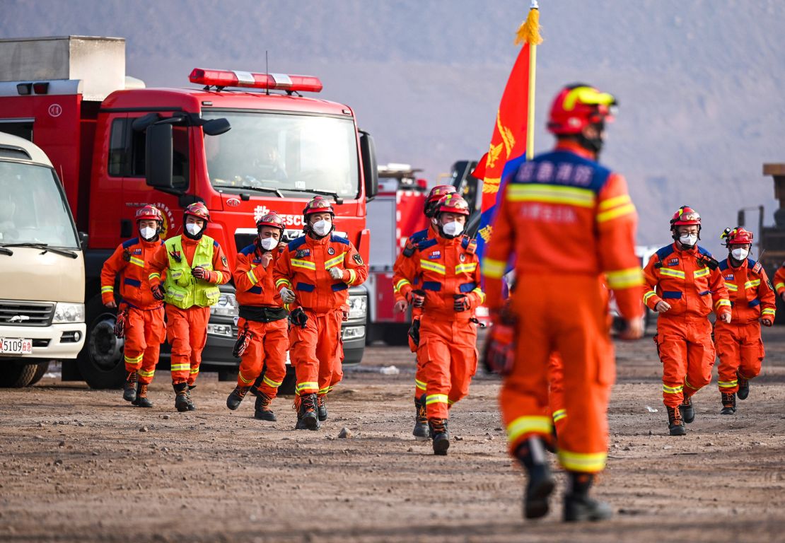 Rescue workers gather at the site.
