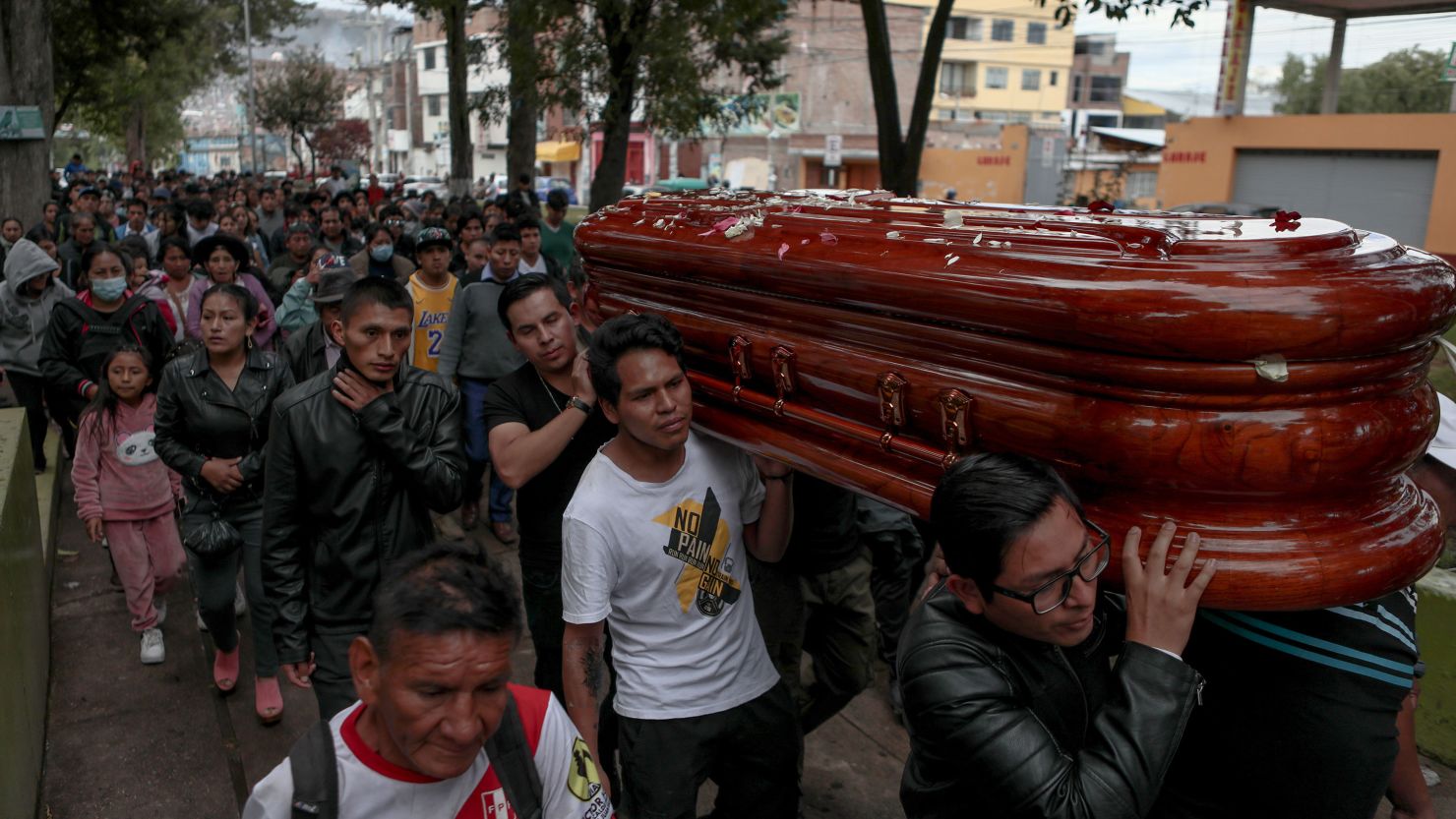 People carry a casket before burying 34-year-old John Henry Mendoza, who died from two bullets to the chest, following protests in Ayacucho.