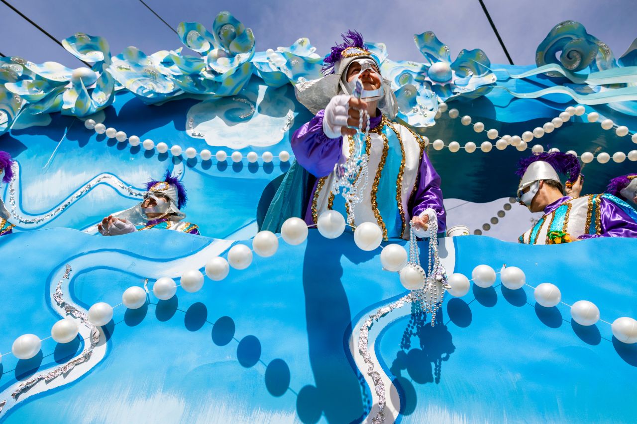 Beads are tossed from a Mardi Gras float in New Orleans on Tuesday, February 21.