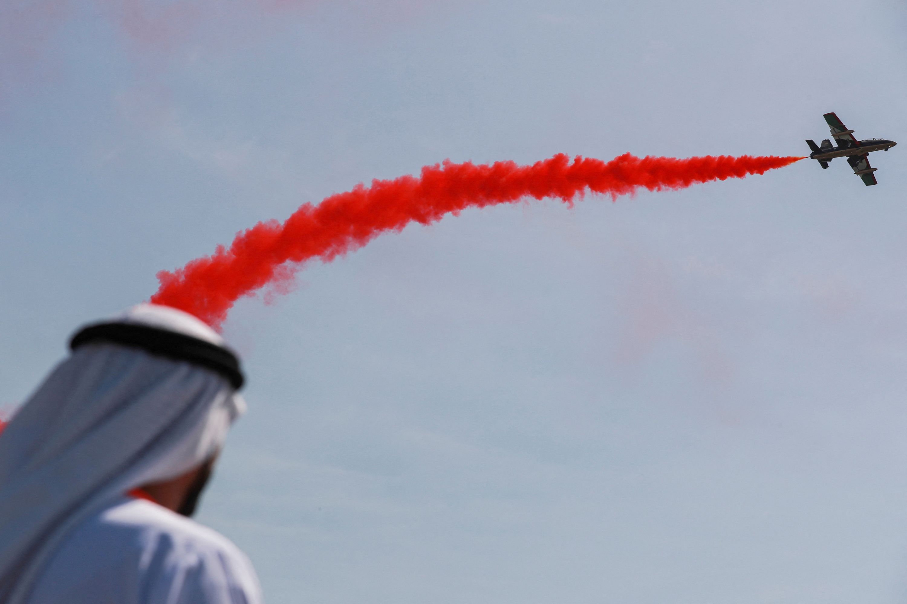 A person watches an air show in Abu Dhabi.