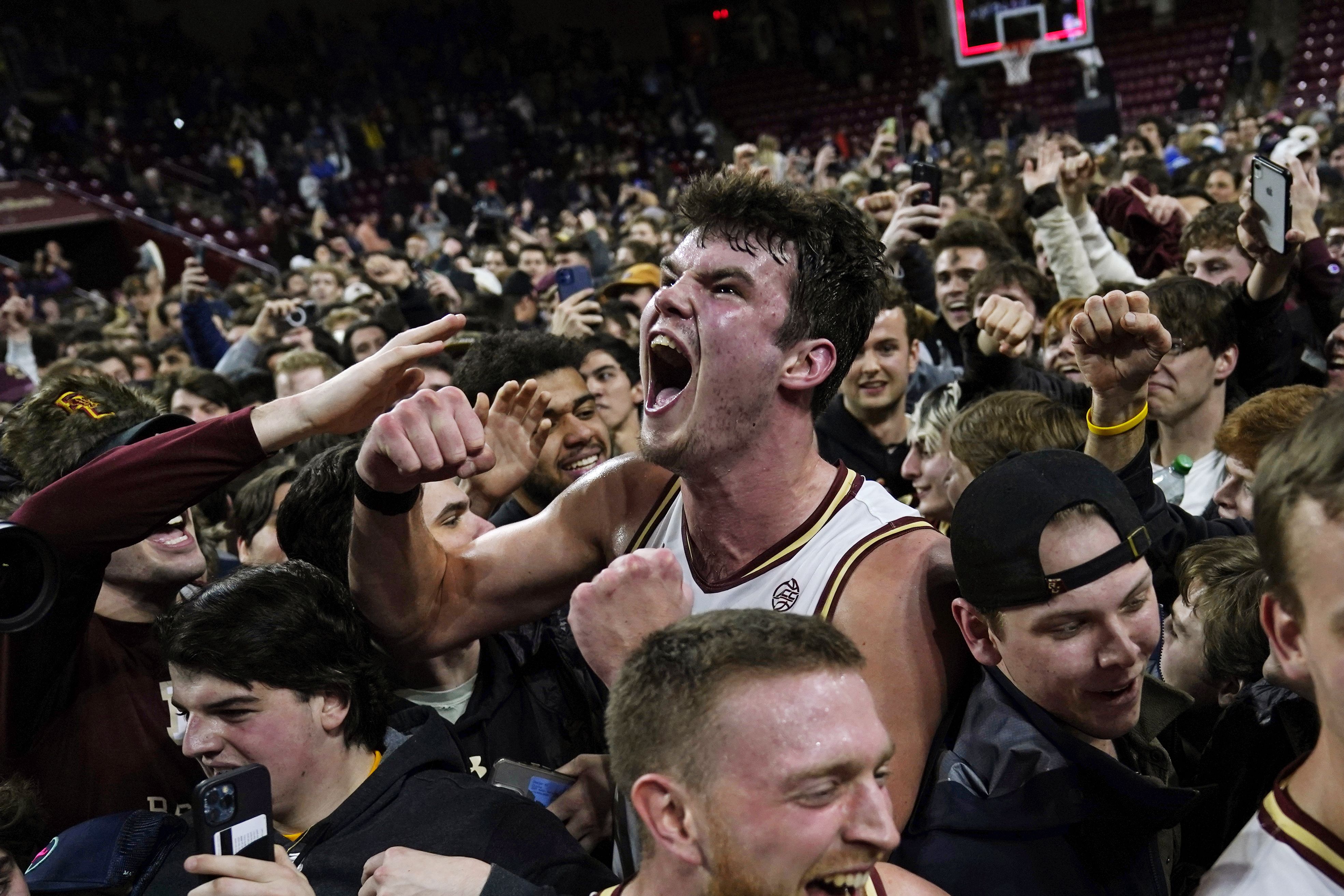 Boston College basketball player celebrates after a victory.