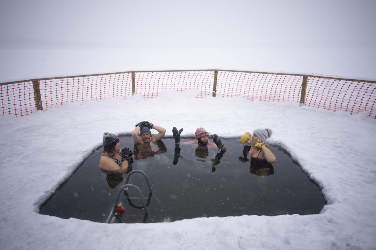 From left, Rachel Banks Kupcho, Matt Nelson, Steve Jewell and Cindy Murphy soak in Minneapolis' Lake Harriet on Wednesday, February 22.