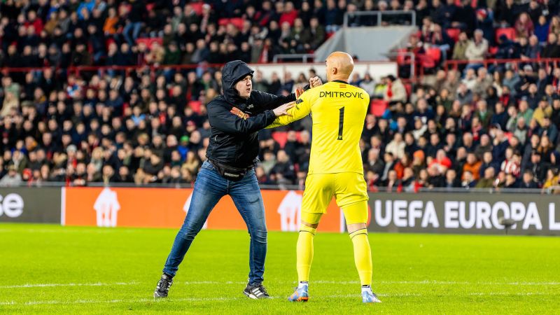 NextImg:Sevilla goalkeeper Marko Dmitrović punched by pitch invader during Europa League match at PSV Eindhoven | CNN