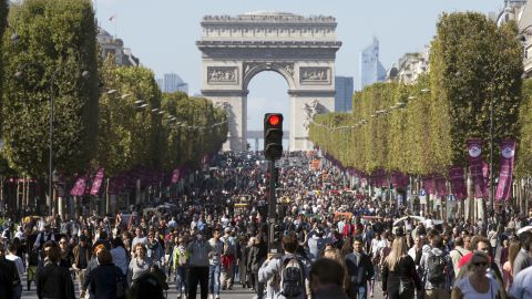 People walk on the Champs-Elysées during a car-free day in central Paris.