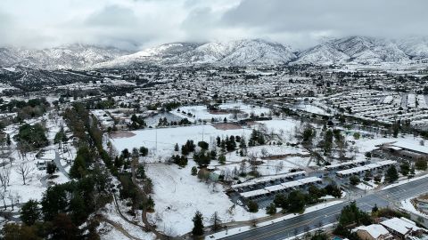 Children enjoy the rare snowfall in Yucaipa with a view of the mountains of San Bernardino County, California. 