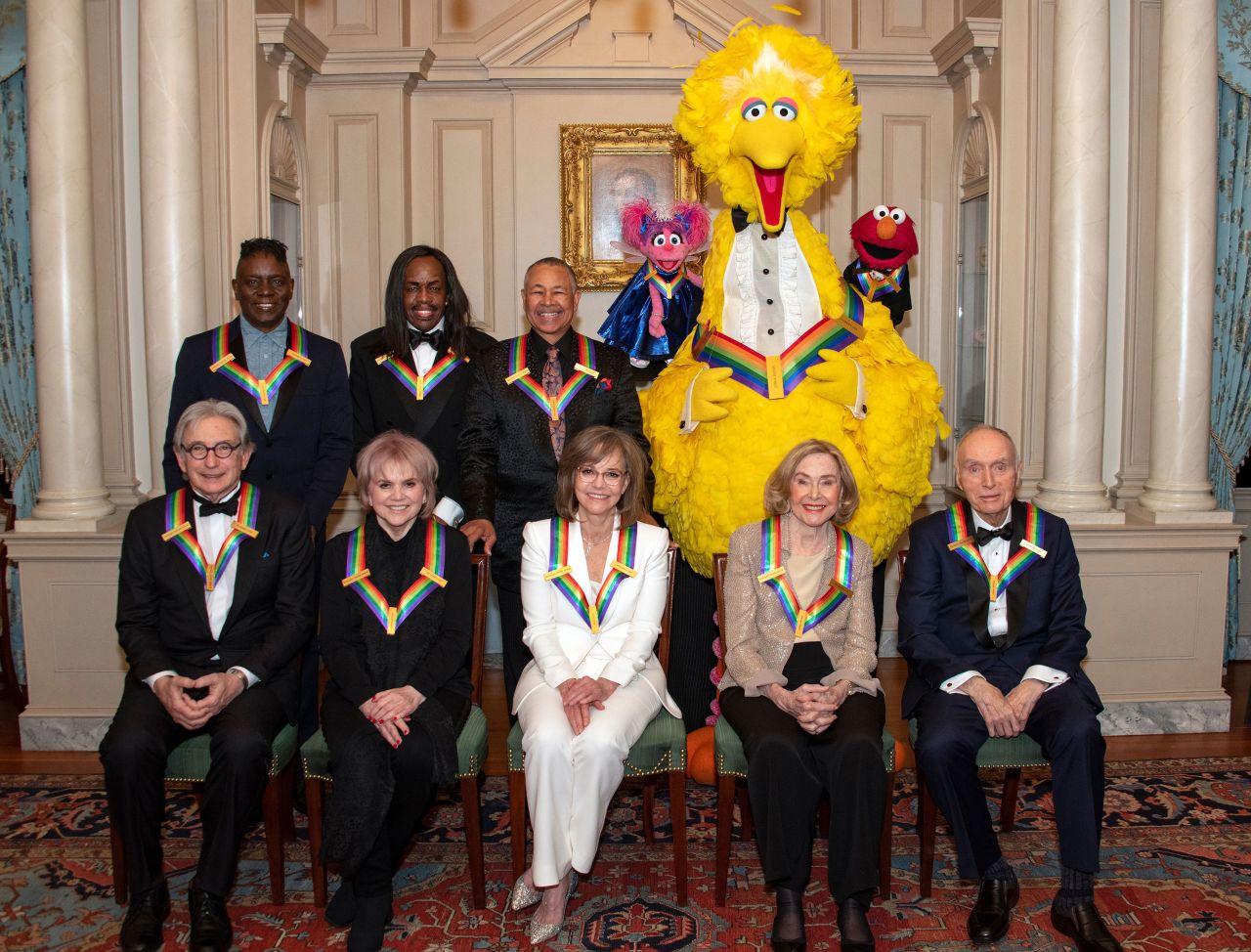 Field, front center, is recognized at the 2019 Kennedy Center Honors. Behind her, in the back row from left, are Earth Wind & Fire members Philip Bailey, Verdine White and Ralph Johnson, and "Sesame Street" characters Abby, Big Bird and Elmo. In the front row, from left, are Michael Tilson Thomas, Linda Ronstadt, Field, Joan Ganz Cooney and Dr. Lloyd Morrisett.