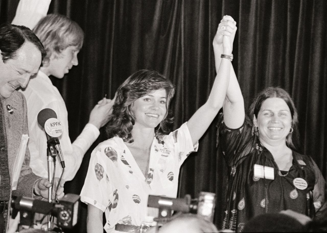 Field holds the hand of Crystal Lee Sutton at a benefit in 1980. Sutton's life story was the basis for "Norma Rae."