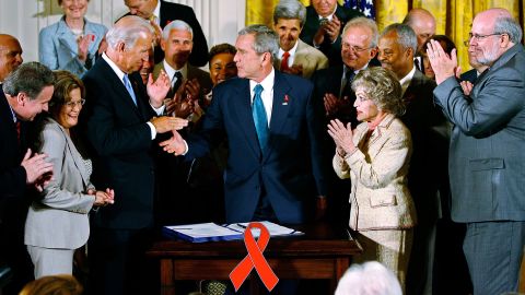 Then-President George W. Bush shakes hands with then-Sen. Joe Biden after signing an act in 2008 that reauthorized PEPFAR.