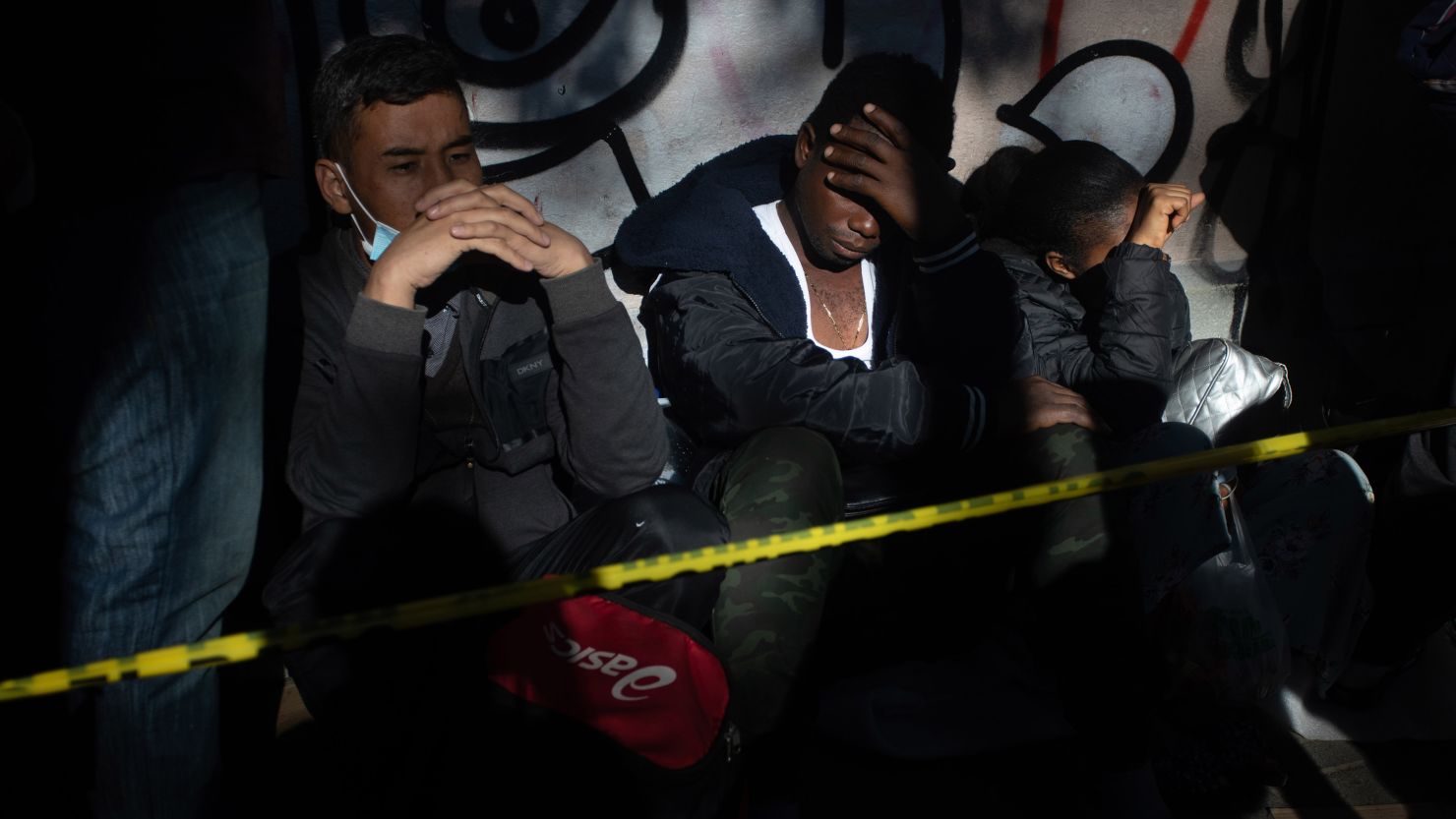 Migrants from Venezuela, Cuba, Haiti and Afghanistan wait outside the Mexican Commission for Refugee Assistance (COMAR) in Mexico City on January 24, 2023.