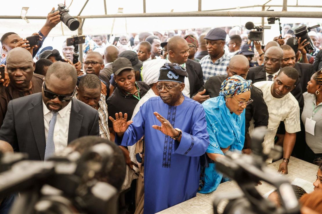 All Progressives Congress (APC) presidential candidate Bola Tinubu and his wife Oluremi Tinubu arrive to vote at a polling station in Lagos on Saturday during Nigeria's presidential and general election.