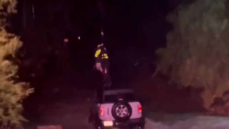 NextImg:See moment driver is rescued from rising flood waters in California | CNN