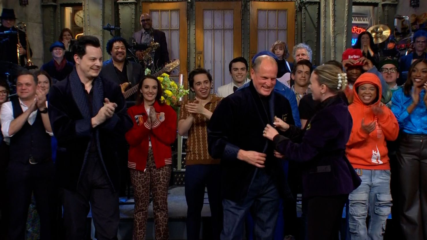 Woody Harrelson receives a "Saturday Night Live" honorary jacket from Scarlett Johansson.