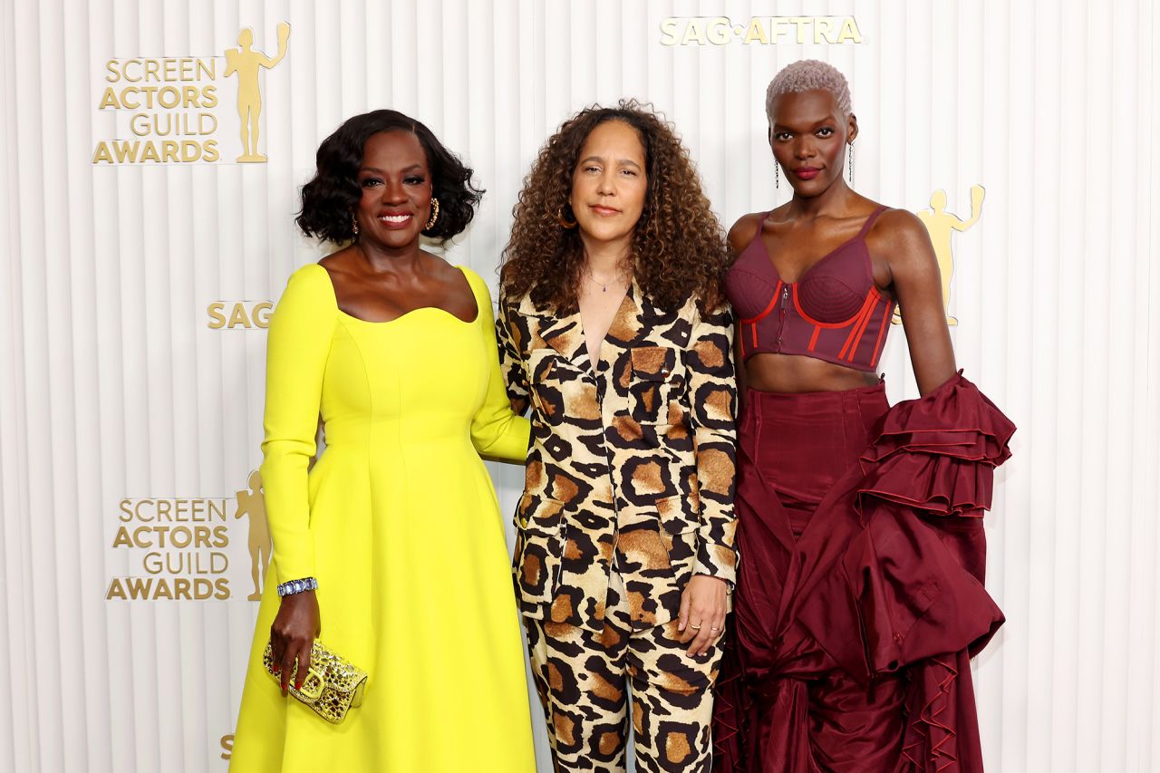 Viola Davis (left), wearing Valentino, poses with "The Woman King" director Gina Prince-Bythewood (center) and co-star Sheila Atim (right).
