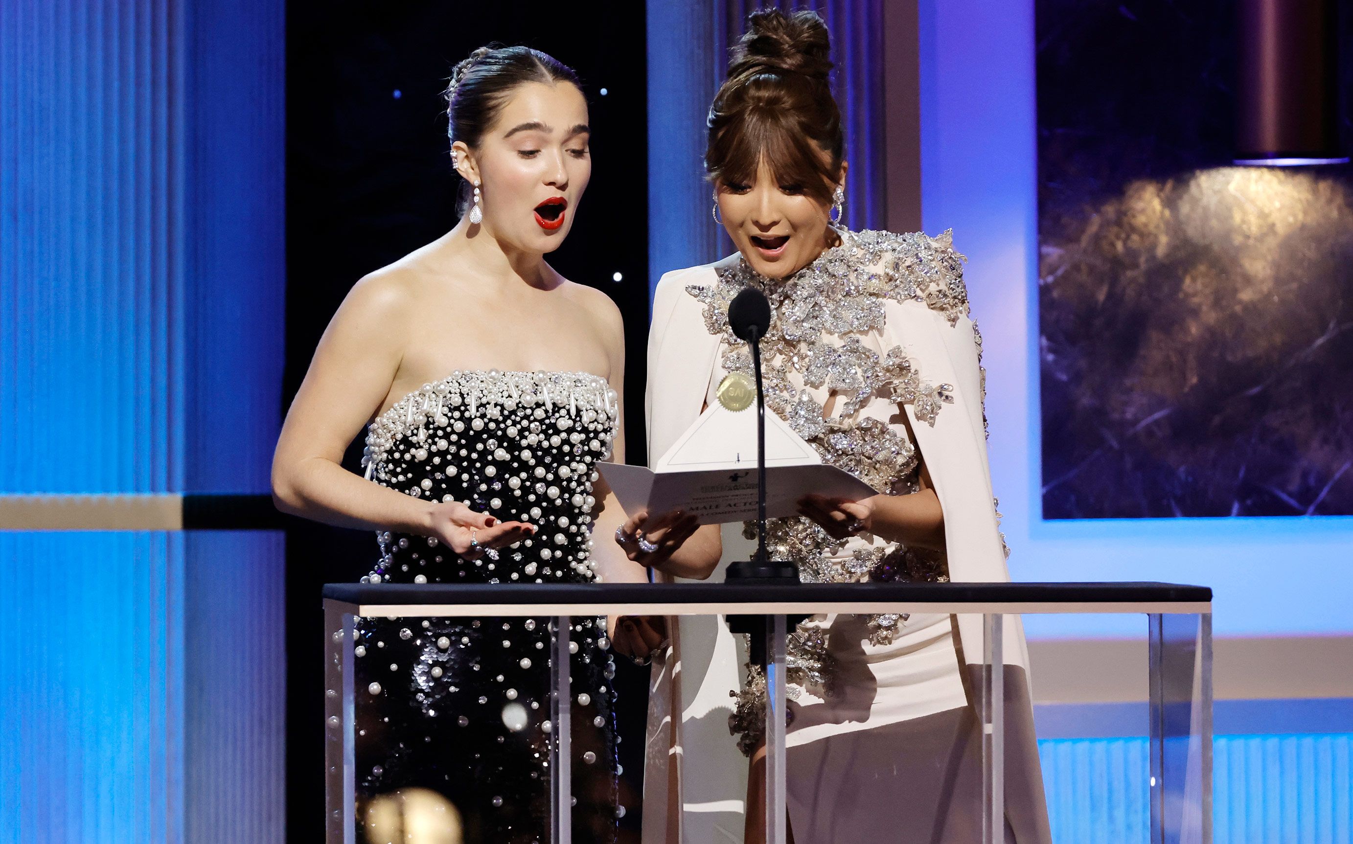 Haley Lu Richardson and Ashley Park present an award. 