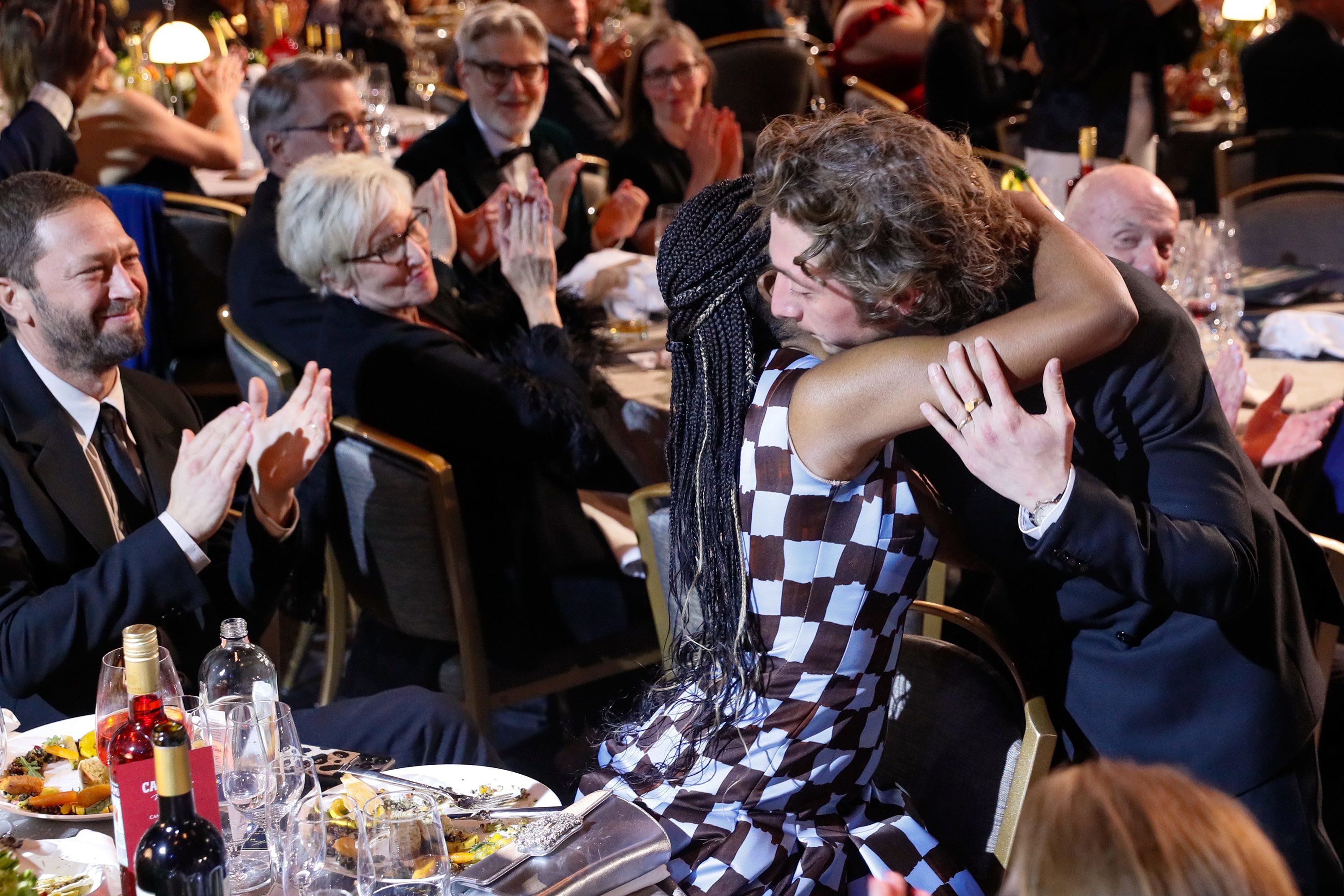 Jeremy Allen White hugs "The Bear" co-star Ayo Edebiri before accepting his award for male actor in a comedy series.