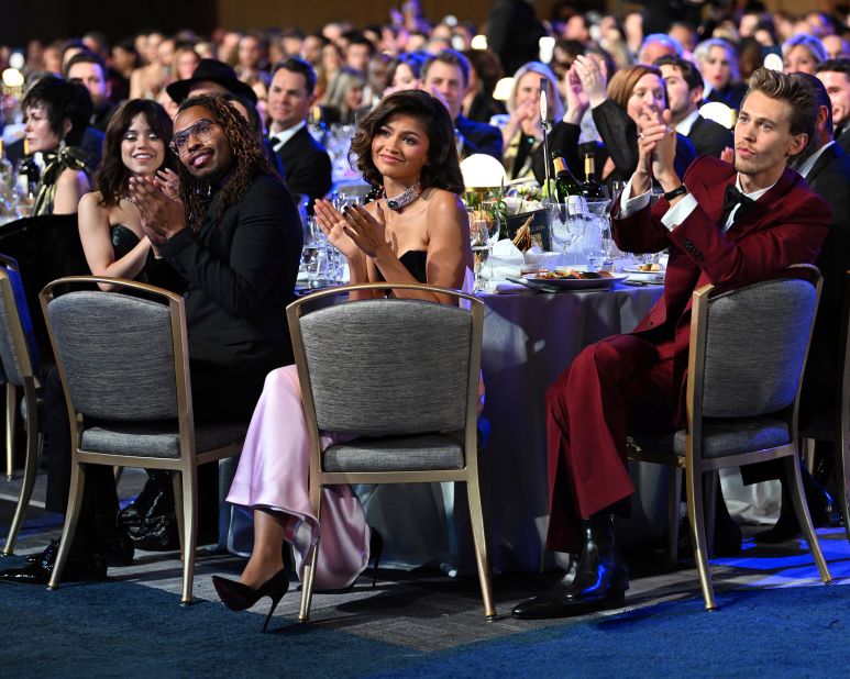 Zendaya, center, and Austin Butler, right, look on from the audience. 