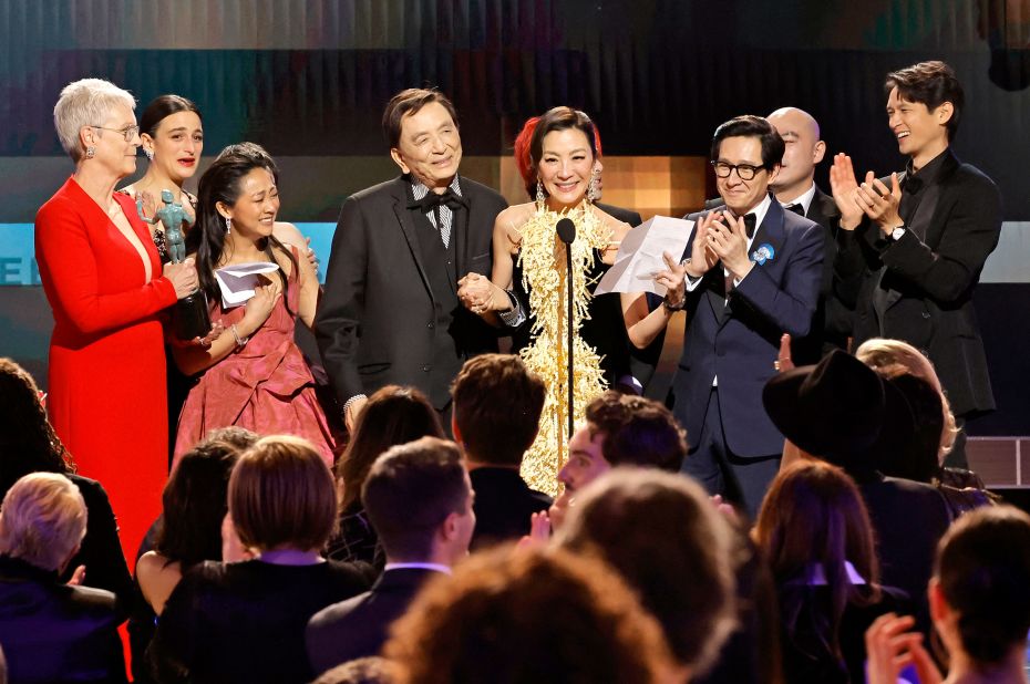 "Everything Everywhere All at Once" cast members accept the award for outstanding performance by a cast in a motion picture.