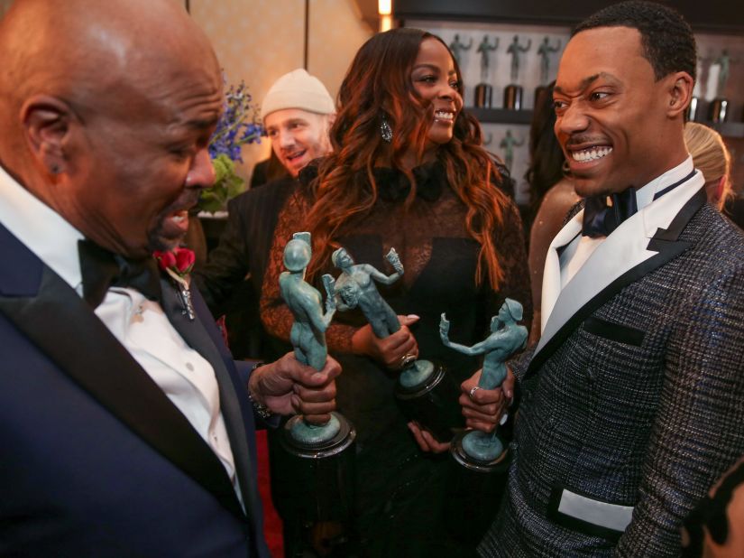 William Stanford Davis, Janelle James and Tyler James Williams hold their awards backstage. 