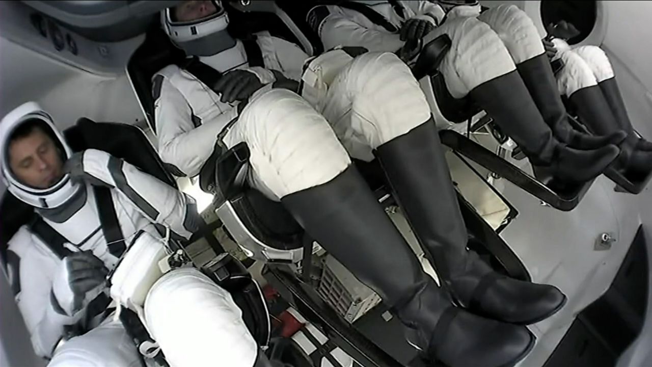 The four astronauts exited the spacecraft after waiting for it to be drained of its fuel.  