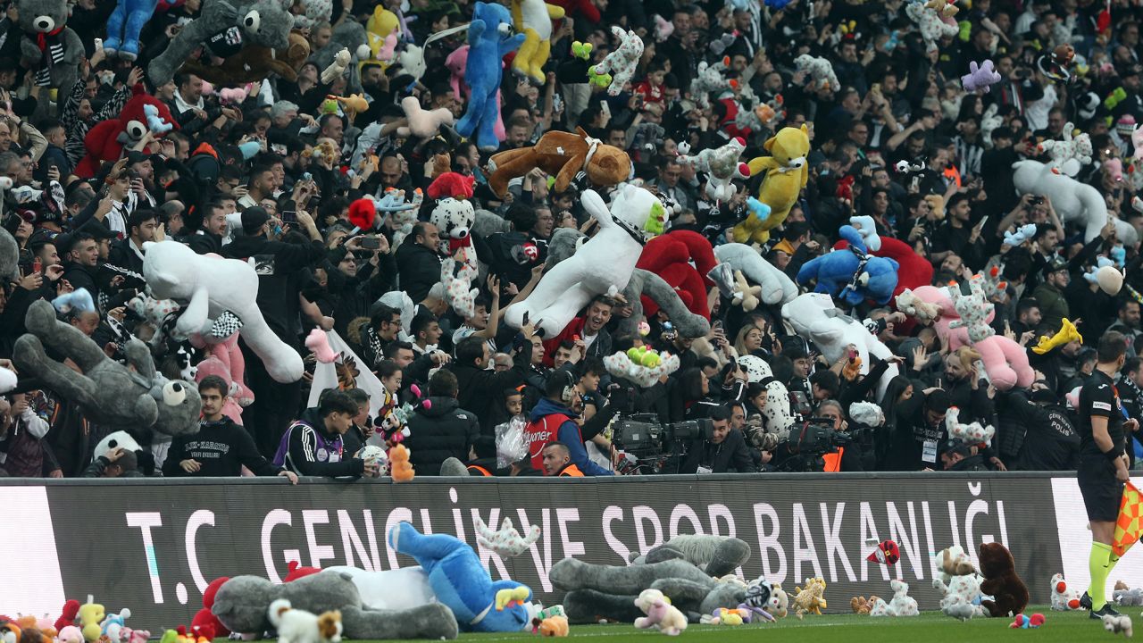 Toys are passed onto the pitch for children affected by the earthquake in Turkey and Syria. 