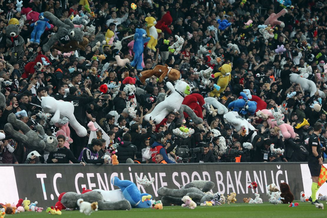 Toys are passed onto the pitch for children affected by the earthquake in Turkey and Syria. 