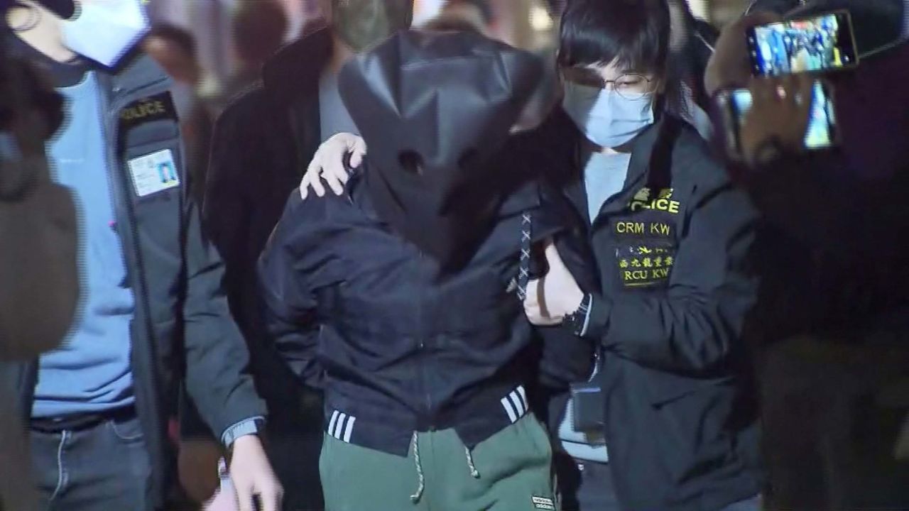 Police officers in Hong Kong on Sunday escort a 47-year-old suspect in connection with Choi's killing, which captured the attention of the city over the weekend.