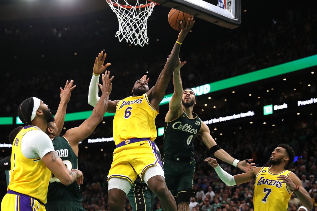 James shoots while Jayson Tatum of the Boston Celtics defends.