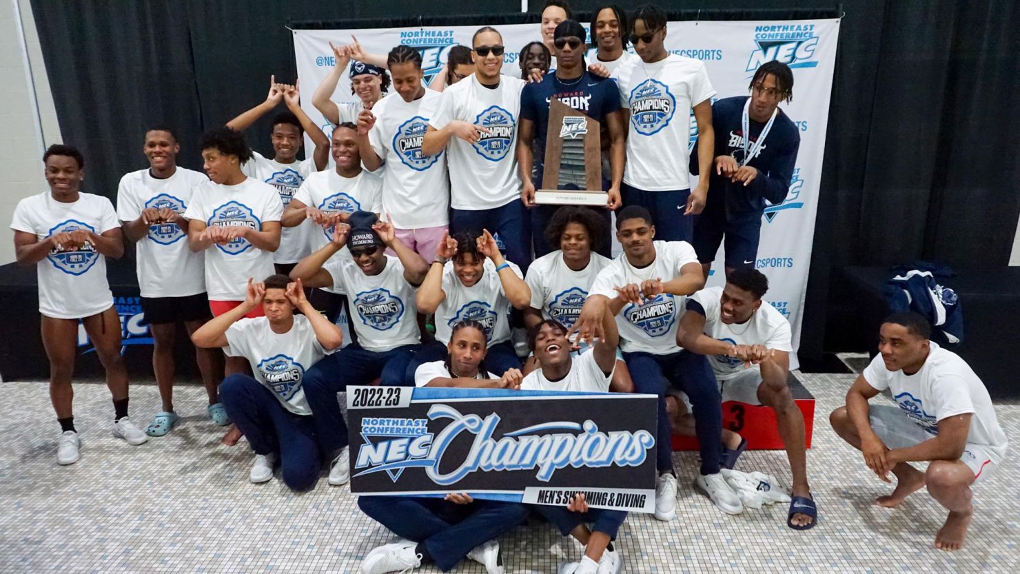 Howard University's men's swimming and diving team celebrates winning the Northeast Conference Championship.
