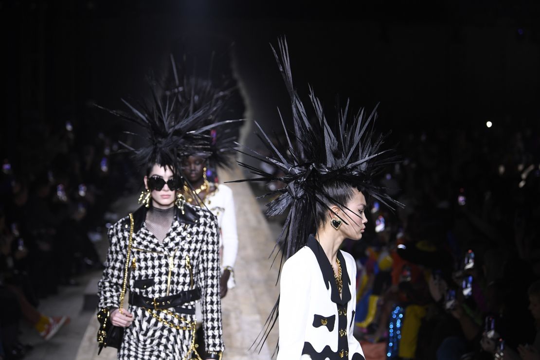 Conservative skirt suits and knit dresses were contrasted against sky-high mohawks at Moschino.