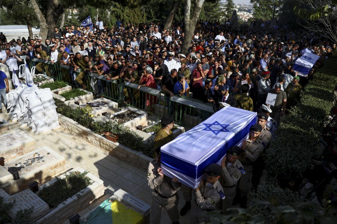People attend the funeral of the brothers Hillel and Yagal Yaniv at the Mount Herzl military cemetery in Jerusalem on Monday.