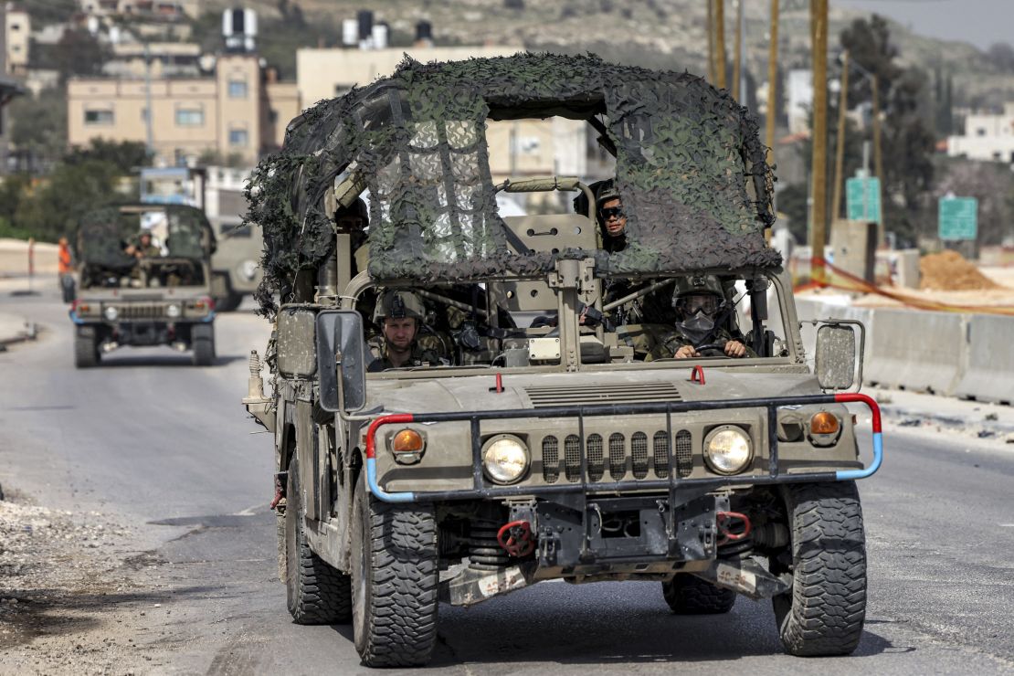 Israeli soldiers ride in a military vehicle in Huwara, near Nablus in the West Bank, on Monday.