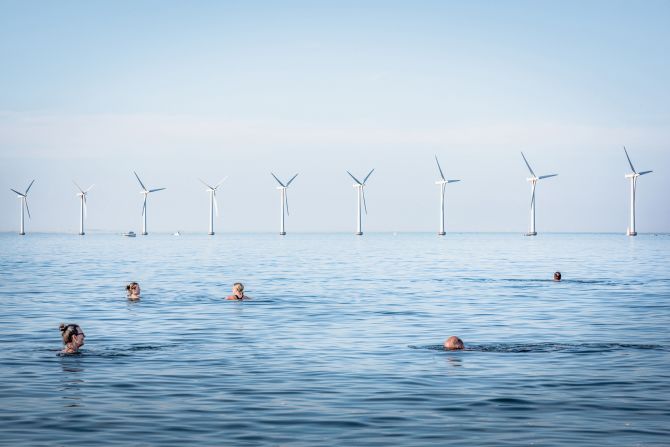 A view of the Middelgrunden offshore wind farm, taken from a beach in Copenhagen, Denmark, by photographer Simone Tramonte.