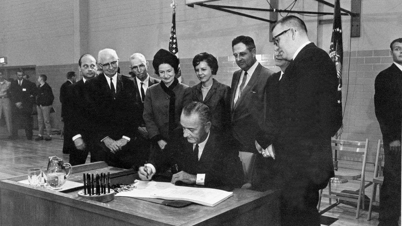 President Lyndon B. Johnson signs the Higher Education Act at San Marcos, Texas, November 8, 1965. 