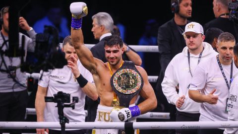 British reality TV star Tommy Fury (C) celebrates after his split decision win against US YouTuber Jake Paul.