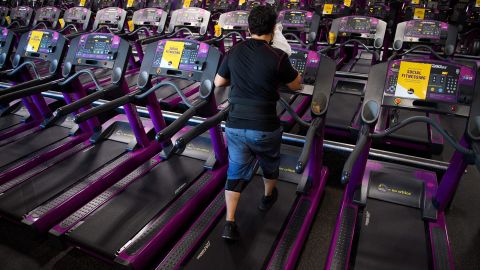 A customer wipes sweat from their face as they work out on a treadmill inside a Planet Fitness Inc. gym as the location reopens after being closed due to the Covid-19 pandemic, on March 16, 2021 in Inglewood, California.