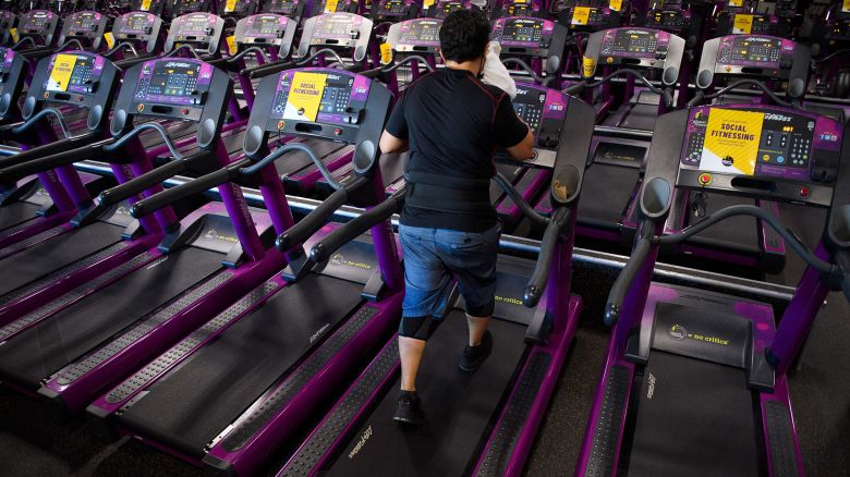 A customer wipes sweat from their face as they work out on a treadmill inside a Planet Fitness Inc. gym as the location reopens after being closed due to the Covid-19 pandemic, on March 16, 2021 in Inglewood, California.