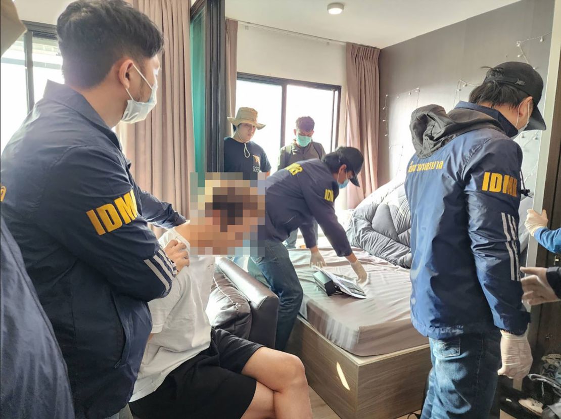 Saharat Sawanjaeng is pictured during the raid where he was arrested in Bangkok on February 23. Sawanjaeng's face has been obscured by Royal Thai Police in this handout image.