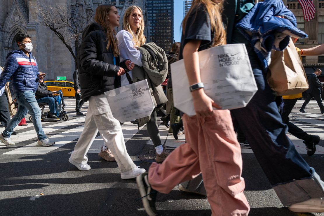 People walk along 5th Avenue in Manhattan, one of the nation's premier shopping streets on February 15, 2023, in New York City. 