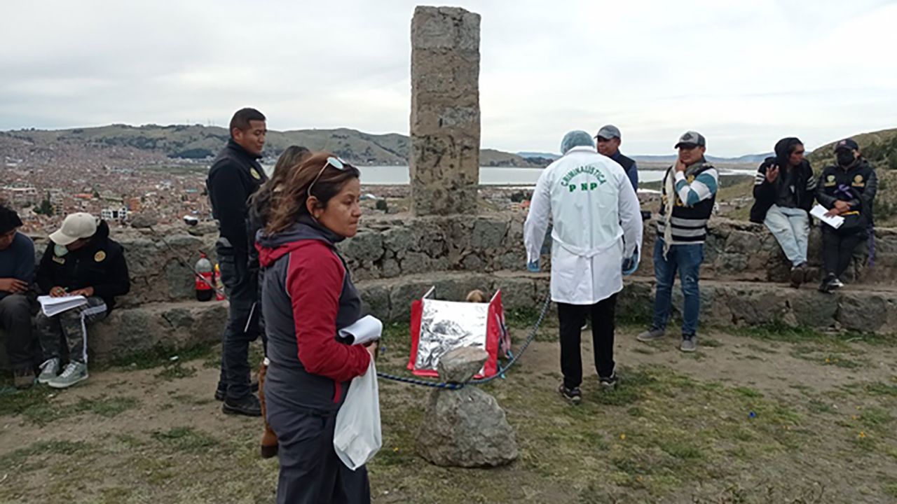 Authorities inspect the mummified body.