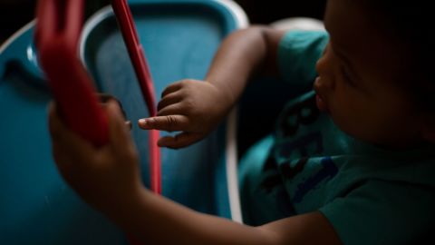 Aurora Bean's 2-year-old son, Kairo, plays on a tablet. Bean began homeschooling her children four years ago.
