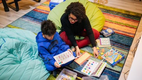 Sherri Mehta and her older son Caleb work on an assignment at their home in Laurel, Mayland. She first turned to homeschooling in 2020.