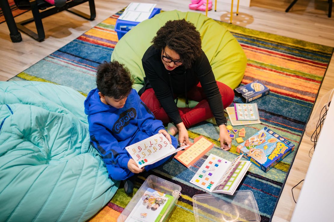 Sherri Mehta and her older son Caleb work on an assignment at their home in Laurel, Mayland. She first turned to homeschooling in 2020.