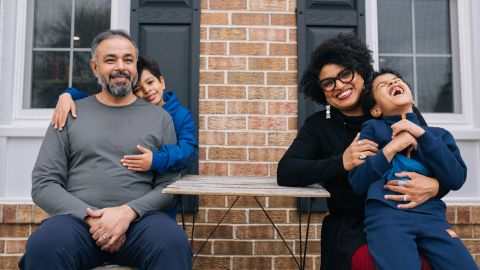 The Mehta family poses for a portrait in front of their Maryland home.