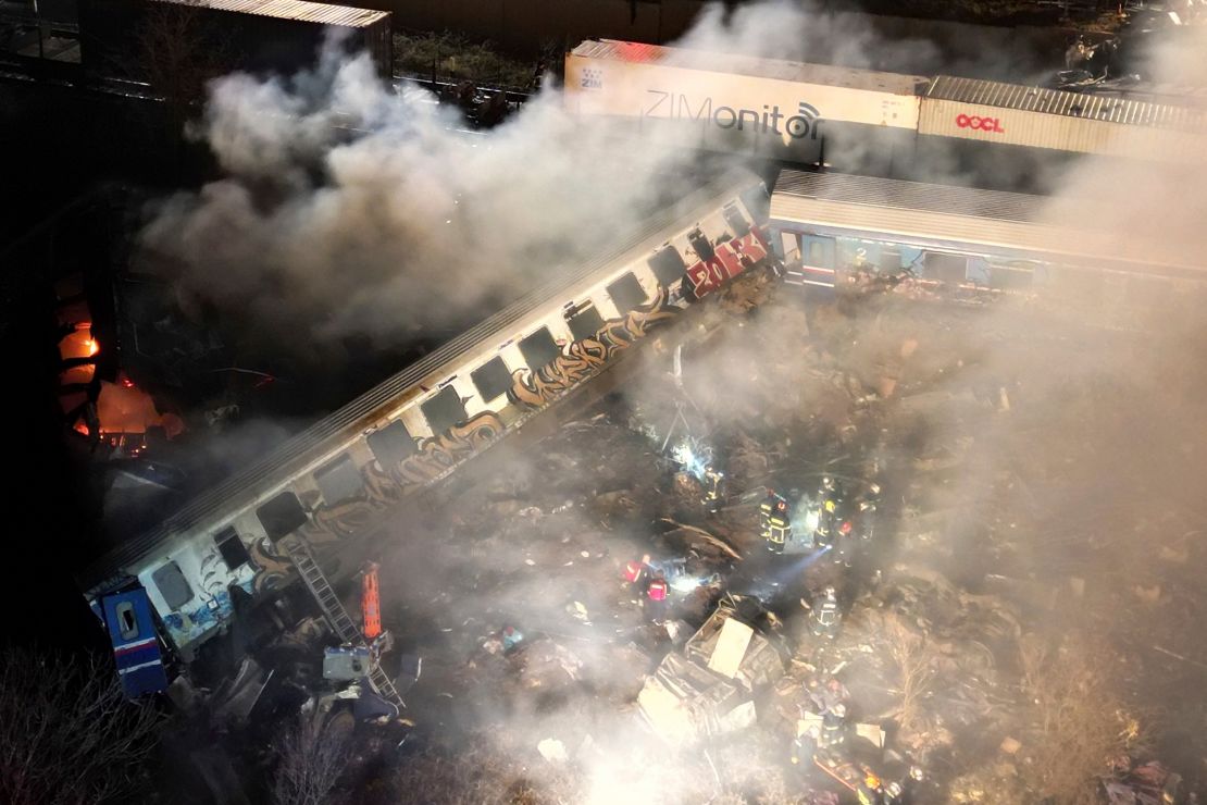 Smoke rises from the derailed train carriages on early Wednesday.