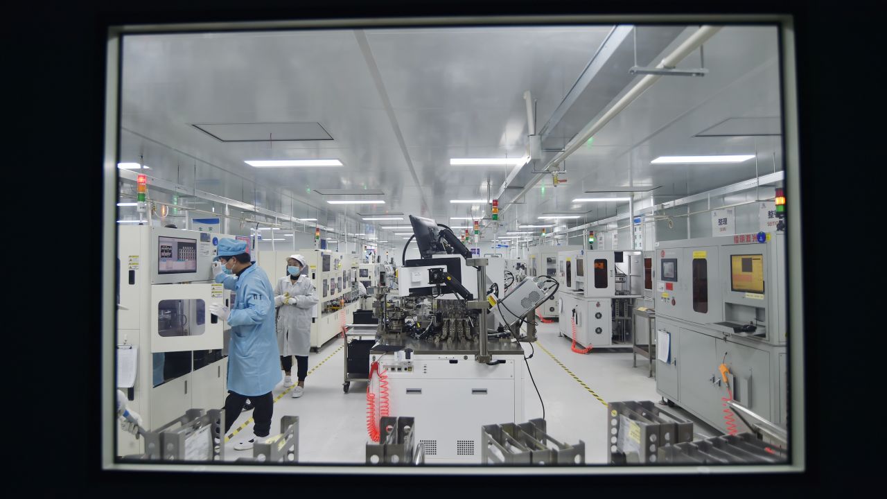 An employee works on the production line of chips at a dust-free workshop of a semiconductor factory on February 28, 2023, in Suqian, Jiangsu province of China.