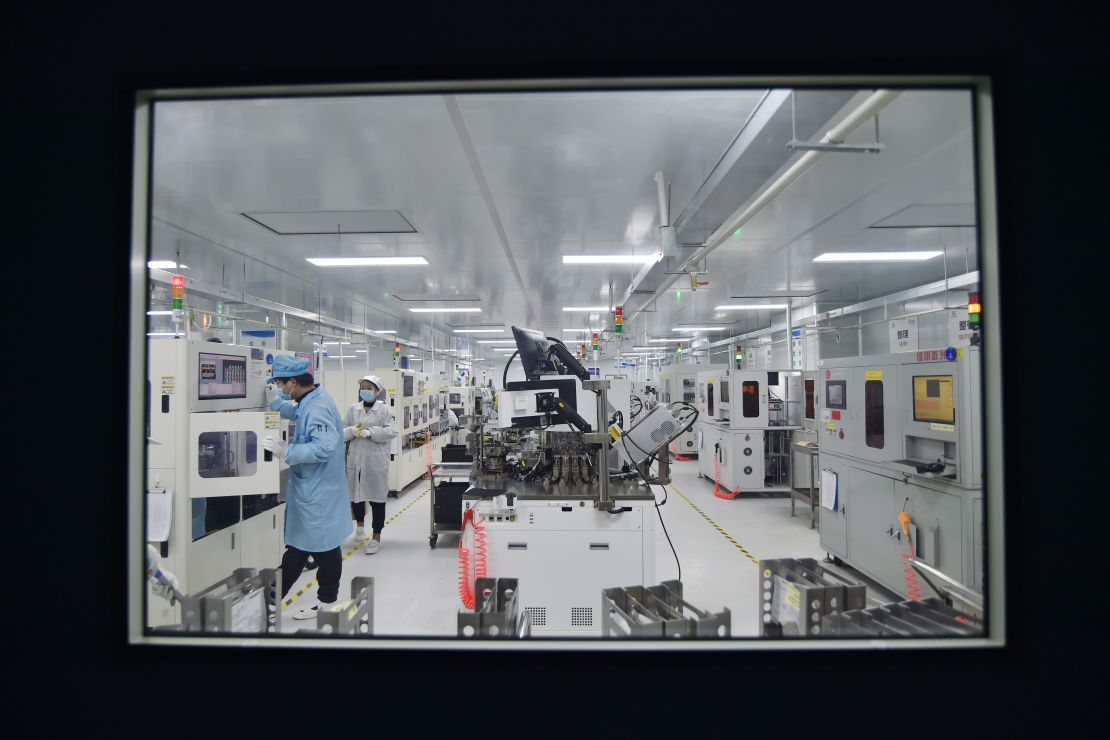 An employee works on the production line of chips at a dust-free workshop of a semiconductor factory on February 28, 2023, in Suqian, Jiangsu province of China.