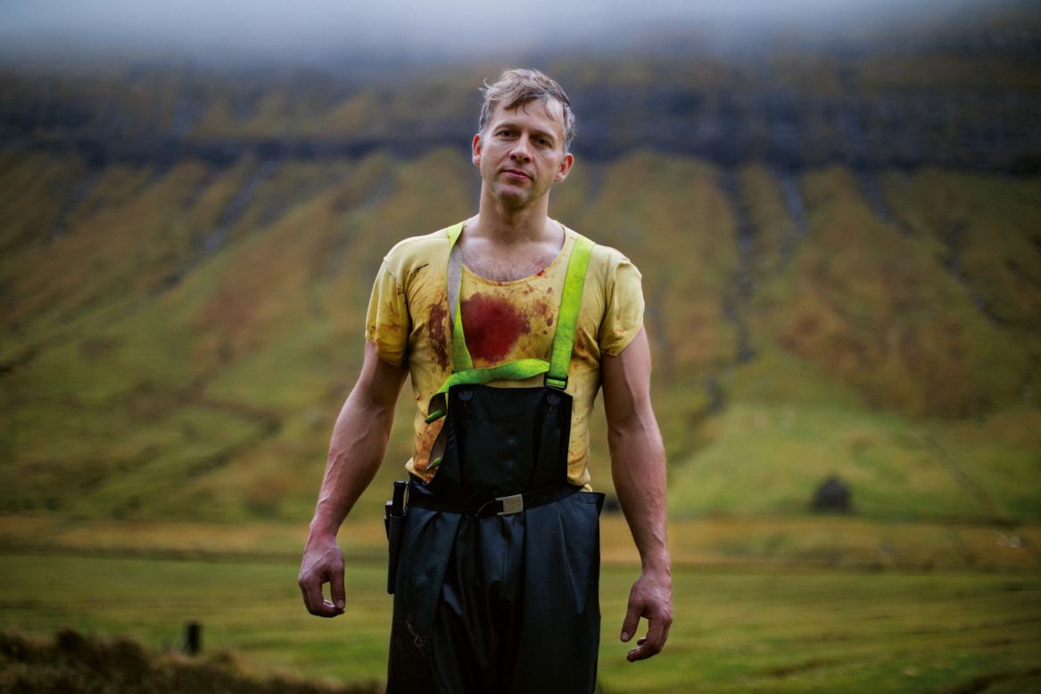 Faroe Islander Hjalmar is pictured while slaughtering sheep on a farm in the village of Kaldbaksbotnur.