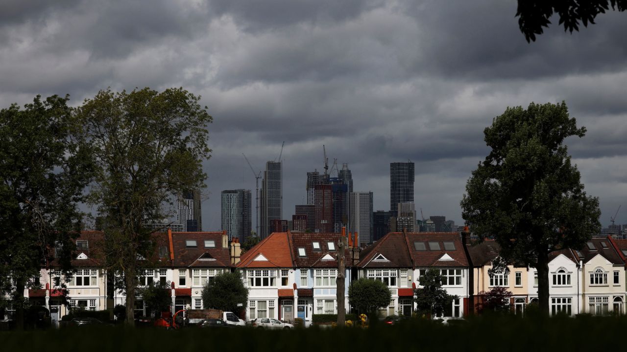 High rise apartments under construction can be seen in the distance behind a row of residential housing in south London, Britain, August 6, 2021.