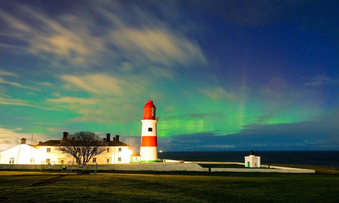 The northern lights, aurora borealis, are pictured here in the late hours of Monday evening above Souter Lighthouse in South Shields, in the northeast of England. 
