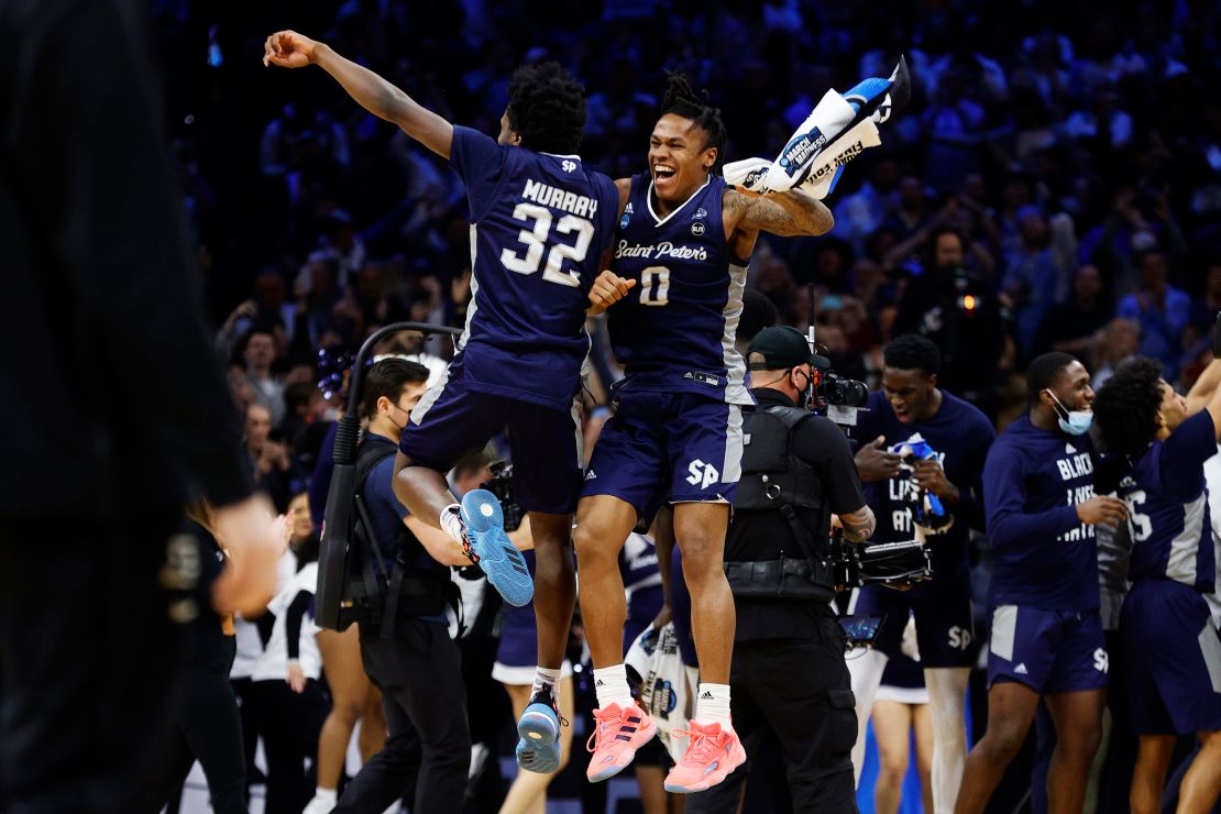 Jaylen Murray and Latrell Reid of the St. Peter's Peacocks celebrate after defeating the Purdue Boilermakers in the Sweet Sixteen round game of the 2022 March Madness.
